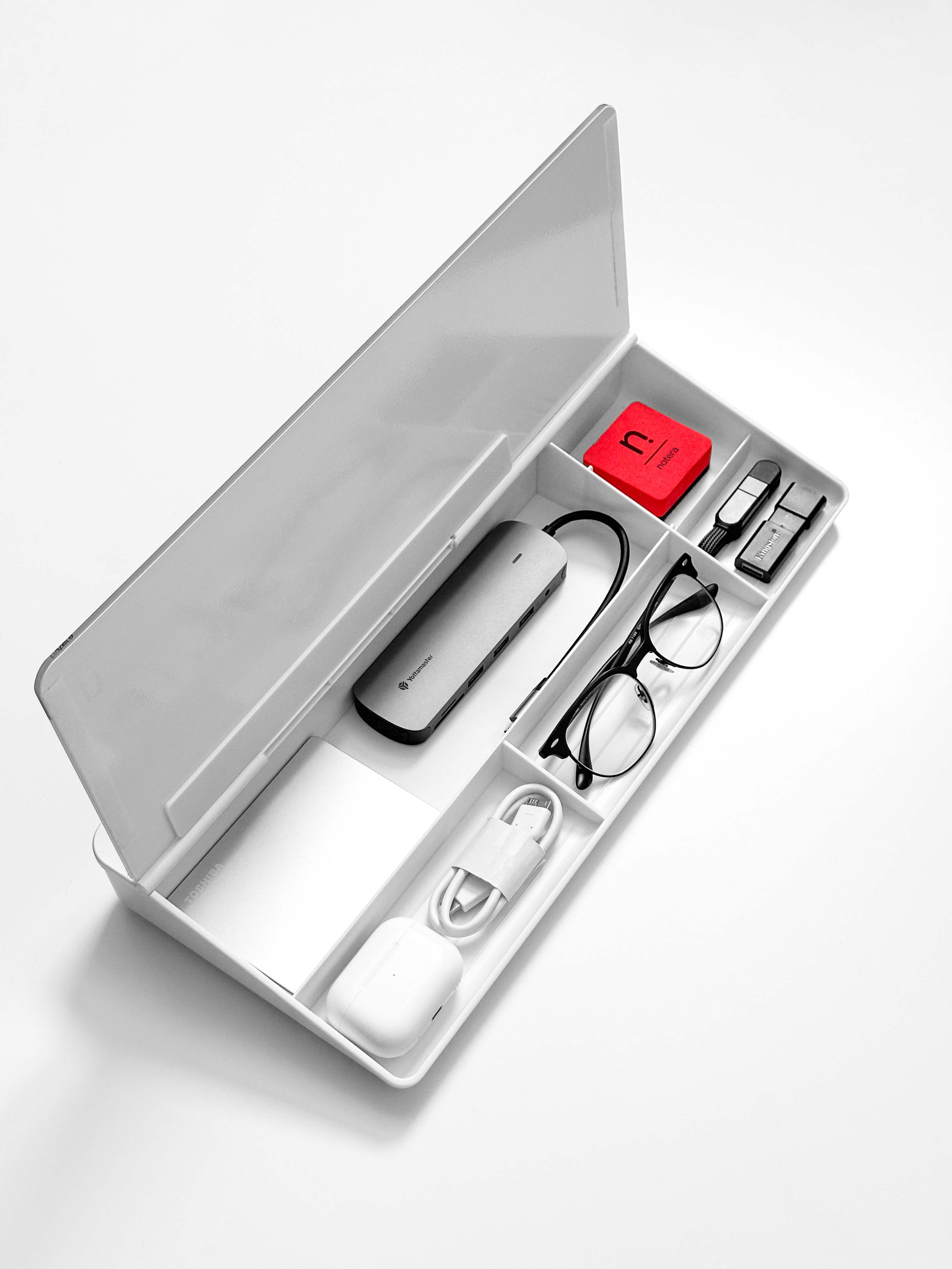 desk accessories neatly organised inside a white Wedge Lite desk organiser