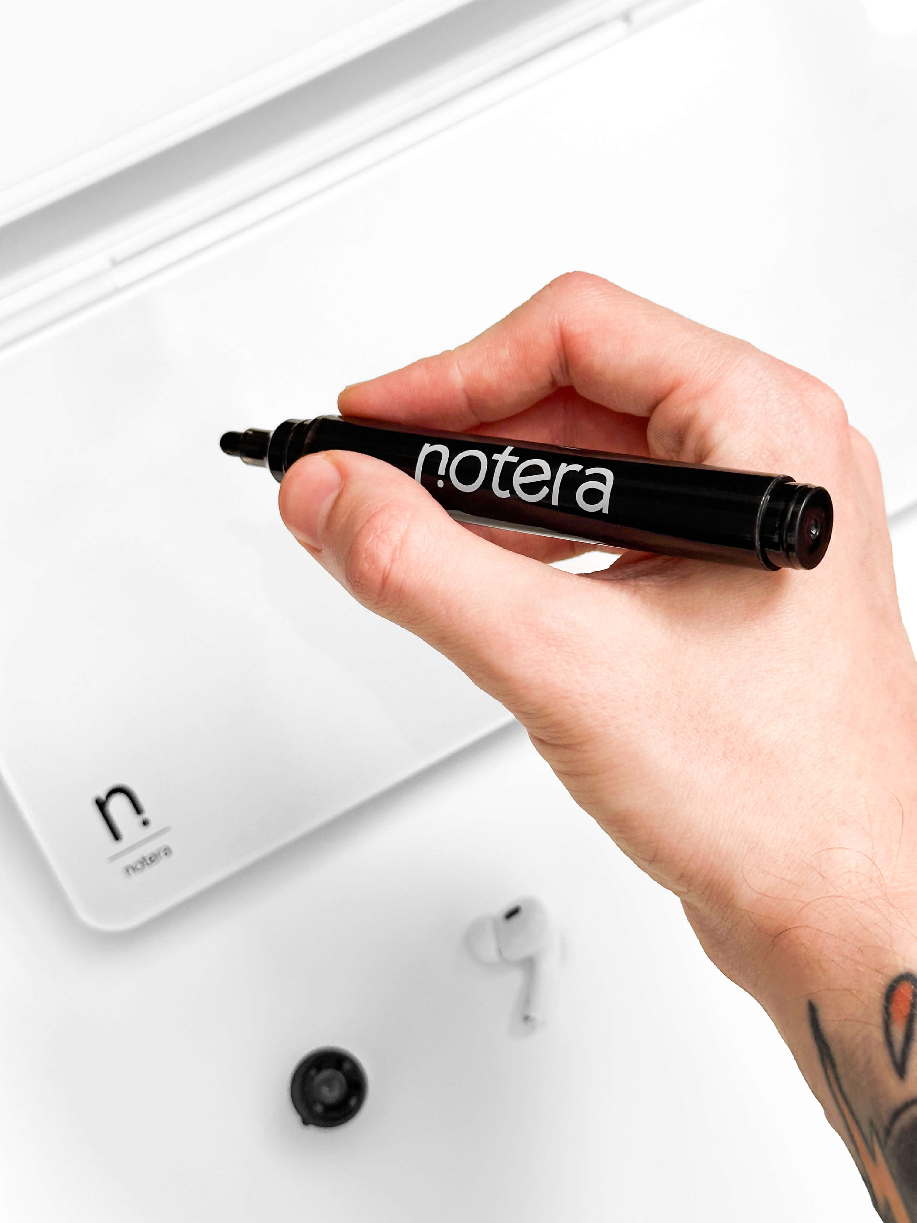 black marker writing on whiteboard surface of white Wedge Lite desk organiser